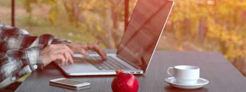 An illuminated tent sits under the milky way.